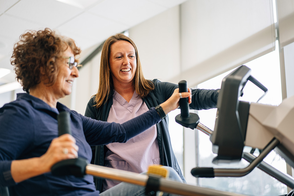 Black River Memorial Hospital pulmonary rehab specialist Kim Schlifer assists a patient.